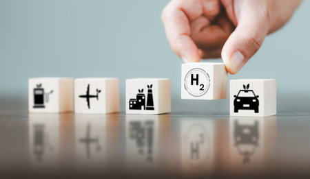 Free Carbon, alternative energy and global climate change concepts. Hand flipping wooden cube blocks with CO2 Carbon dioxide, change to H2 Hydrogen text on table background. Sustainable car energy.の写真素材