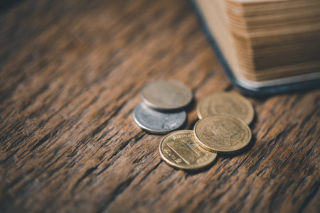 One tenth or tithe is basis on which Bible teaches us to give one tenth of first fruit to God. coins with Holy Bible. Biblical concept of Christian offering, generosity, and giving tithes in church.の写真素材