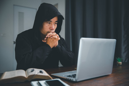 Christian online technology concept. Hands praying of christian with digital computer laptop, Online...
