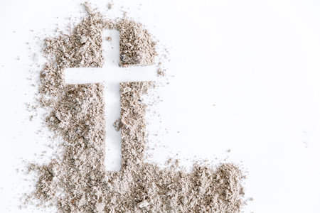 Christian cross or crucifix drawing in ash, dust or sand as symbol of religion, sacrifice, redemption, Jesus Christ, ash wednesday, lent, Good Friday, Easter with Church is devoted to fastingの写真素材