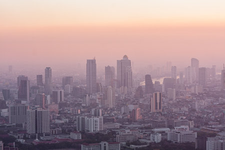 Bad air pollution in City. PM 2.5 dust in Bangkok or center city, Capital city are covered by heavy smog, Misty morning and sunrise in downtown with bad air pollution, Place to risk of cancer,Thailandの写真素材