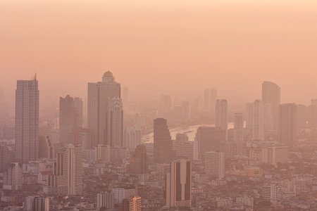 Bad air pollution in City. PM 2.5 dust in Bangkok or center city, Capital city are covered by heavy smog, Misty morning and sunrise in downtown with bad air pollution, Place to risk of cancer,Thailandの写真素材