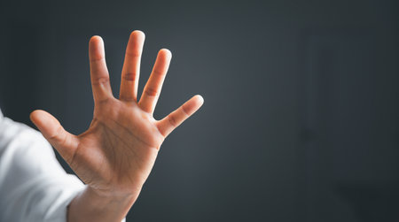 Stop violence against women concept, international women's day. Female hand raised in fear and stop...