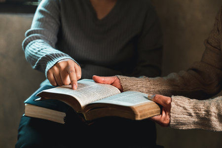 Small group of asian people praying worship believe. Teams of friends worship together before studying Holy bible. family praying together in church. Small group learning with prayer concept.の写真素材