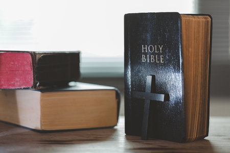 Holy bible book for education on wooden table with background. Christian catholic with protestant worship and pray in church. Concept of learning about faith god and religion, jesus spiritual.の写真素材