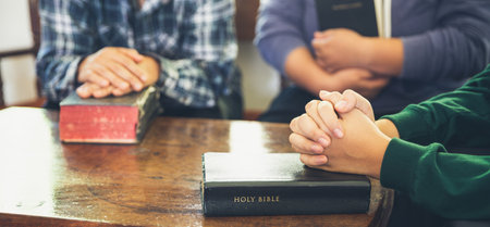 Small group of asian people praying worship believe. Teams of friends worship together before...