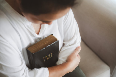 Asian woman reading the bible. Female hands praying to god. Begging for forgiveness and believe in goodness. Christian life crisis prayer to god. Pray for god blessing to wishing have a better life.の写真素材