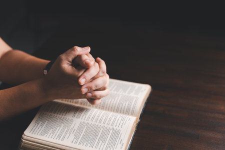 Woman hands praying to god with the bible. Woman pray for god blessing to wishing have a better...