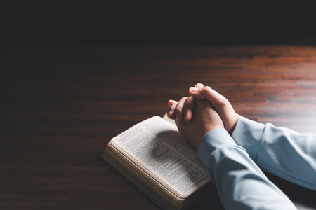 Woman hands praying to god with the bible. Woman pray for god blessing to wishing have a better life. begging for forgiveness and believe in goodness. Holy Bible in church concept for faith.の写真素材