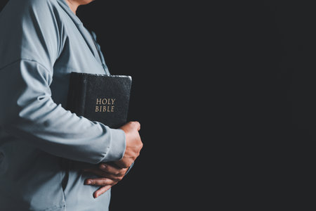 A Holy Bible in church concept for faith. Woman pray for god blessing to wishing have a better life. begging for forgiveness and believe in goodness. Holy Bible in church concept for faith.の写真素材