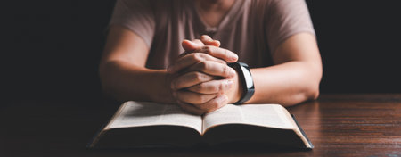 Woman hands praying to god with the bible. Woman pray for god blessing to wishing have a better life. begging for forgiveness and believe in goodness. Holy Bible in church concept for faith.の写真素材