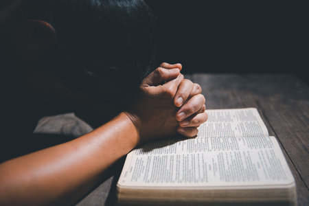 Christian life crisis prayer to god. Woman pray for god blessing to wishing have a better life. Female hands praying to god with the bible. begging for forgiveness and believe in goodness.の写真素材