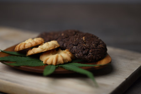 Cannabis or Marijuana cookies is Delicious homemade cookies with CBD. And leaf garnish. Medicinal Edibles. Treatment of medical marijuana. The Cannabis is green herbal medicine is healthy delicious.の写真素材
