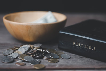 One tenth or tithe is basis on which Bible teaches us to donate one tenth of first fruit to God. Coins with Holy Bible. Religion donation and funding. Giving money, the symbol of Christianity donationの写真素材