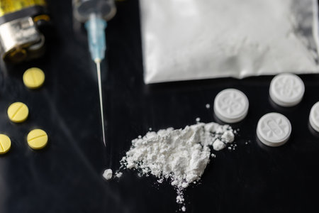 Drug or narcotic is all type of medicine. Addiction to cocaine heroin are harmful to death. drugs are illegal or forbidden. Heroin is a a powder people use syringe and inject into their blood.の写真素材