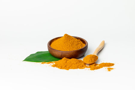 The turmeric powder is a natural herb and is an ingredient for food cooking. The colour of the turmeric powder is yellow when it dry and green when it raw. Asian curry like Indian has yellow powder.の写真素材