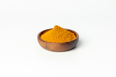 The turmeric powder is a natural herb and is an ingredient for food cooking. The colour of the turmeric powder is yellow when it dry and green when it raw. Asian curry like Indian has yellow powder.の写真素材