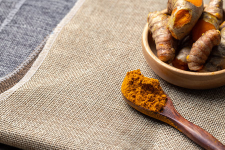 The turmeric powder is a natural herb and is an ingredient for food cooking. The colour of the turmeric powder is yellow when it dry and green when it raw. Asian curry like Indian has yellow powder.の写真素材