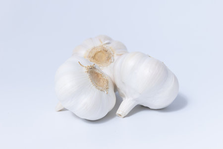 Fresh garlic herb food on a white background.This culinary ingredient adds natural flavor and aroma to your meals. Ideal for gourmet cooking and food styling. A tasty addition to any recipe.の写真素材