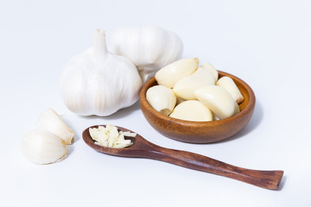 Fresh garlic herb food on a white background.This culinary ingredient adds natural flavor and aroma to your meals. Ideal for gourmet cooking and food styling. A tasty addition to any recipe.の写真素材