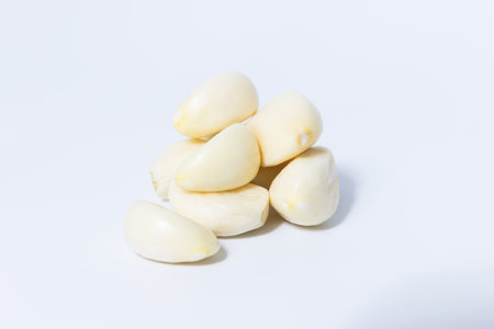 Fresh garlic herb food on a white background.This culinary ingredient adds natural flavor and aroma to your meals. Ideal for gourmet cooking and food styling. A tasty addition to any recipe.の写真素材