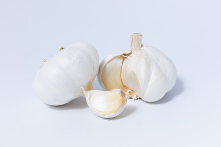 Fresh garlic herb food on a white background.This culinary ingredient adds natural flavor and aroma to your meals. Ideal for gourmet cooking and food styling. A tasty addition to any recipe.の写真素材