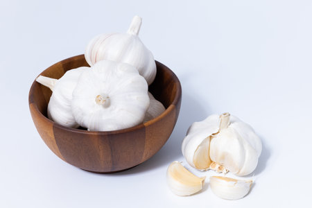 Fresh garlic herb food on a white background.This culinary ingredient adds natural flavor and aroma to your meals. Ideal for gourmet cooking and food styling. A tasty addition to any recipe.の写真素材