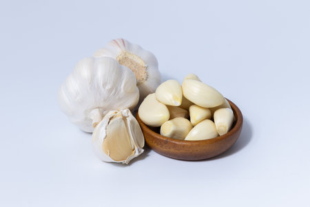 Fresh garlic herb food on a white background.This culinary ingredient adds natural flavor and aroma to your meals. Ideal for gourmet cooking and food styling. A tasty addition to any recipe.の写真素材