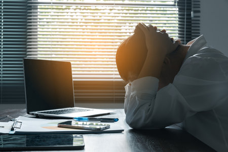 A woman battles depression and stress in her workplace, highlighting the challenges faced by professionals. This image captures the impact of mental health on employees in a corporate environment.の写真素材