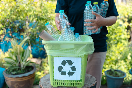 Plastic bottle waste for recycling, reuse concept. Volunteers store plastic bottles in cardboard boxes at a park. Disposal, recycling and waste management. Good conscience.の写真素材