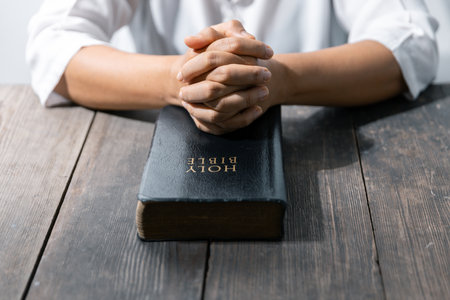 Christian life crisis prayer to god. Woman Pray for god blessing to wishing have a better life. woman hands praying to god with the bible. begging for forgiveness and believe in goodness.の写真素材
