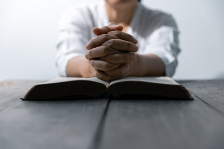 Christian life crisis prayer to god. Woman Pray for god blessing to wishing have a better life. woman hands praying to god with the bible. begging for forgiveness and believe in goodness.の写真素材