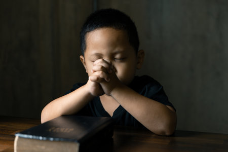 Hands together in prayer to God along with the bible In the Christian concept of faith, spirituality and religion, men pray in the Bible. prayer bibleの写真素材
