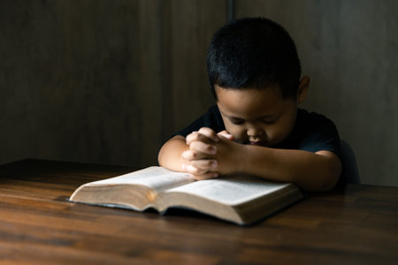 Hands together in prayer to God along with the bible In the Christian concept of faith, spirituality and religion, men pray in the Bible. prayer bibleの写真素材
