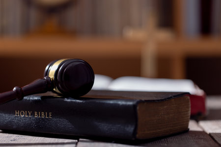 Holy bible book and judge's gavel on table background. Judicial system, constitution, democracy, rule of law. There are no people in the photo. There is free space to insert.の写真素材