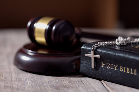 Holy bible book and judge's gavel on table background. Judicial system, constitution, democracy, rule of law. There are no people in the photo. There is free space to insert.の写真素材