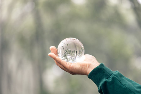 Concept of the Environment World Earth Day. Environment Earth Day In the hands holding green earth on green Background, Saving environment, and environmentally sustainable. Save Earth.の写真素材