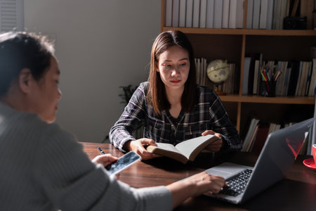 Christian online technology concept. Hands praying of christian with digital computer laptop, Online live church for sunday service. Asian catholic man are reading Holy bible book and online study.の写真素材