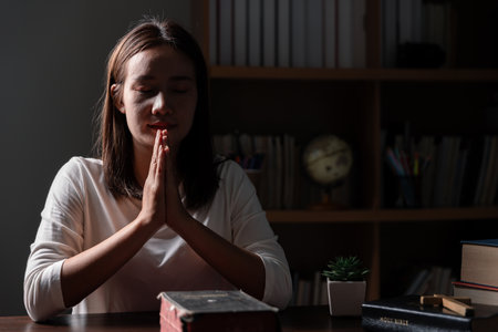 Christian life crisis prayer to god. Woman Pray for god blessing to wishing have a better life. woman hands praying to god with the bible. begging for forgiveness and believe in goodness.の写真素材