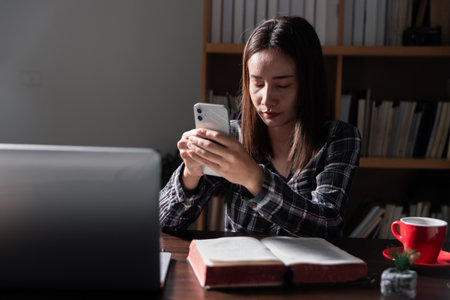 Christian online technology concept. Hands praying of christian with digital computer laptop, Online live church for sunday service. Asian catholic man are reading Holy bible book and online study.の写真素材