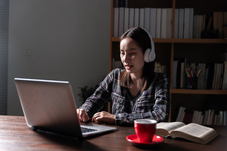 Christian online technology concept. Hands praying of christian with digital computer laptop, Online live church for sunday service. Asian catholic man are reading Holy bible book and online study.の写真素材