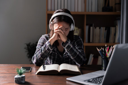 Christian online technology concept. Hands praying of christian with digital computer laptop, Online live church for sunday service. Asian catholic man are reading Holy bible book and online study.の写真素材