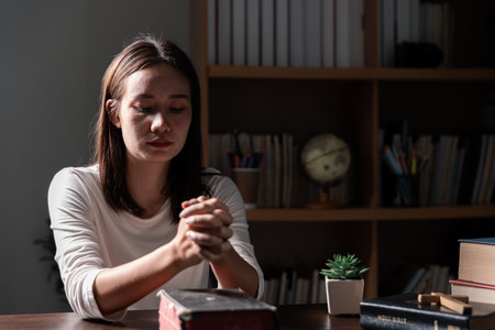 Christian life crisis prayer to god. Woman Pray for god blessing to wishing have a better life. woman hands praying to god with the bible. begging for forgiveness and believe in goodness.の写真素材