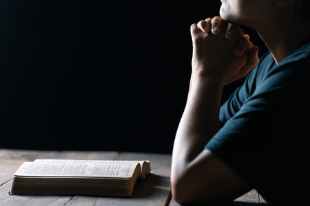 Christian life crisis prayer to god. Woman Pray for god blessing to wishing have a better life. woman hands praying to god with the bible. begging for forgiveness and believe in goodness.の写真素材