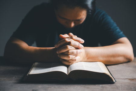 Worship christian with bible concept. Young woman person hand holding holy bible with study at home. Adult female christian reading book in church. Girl learning religion spirituality and pray to god.の写真素材