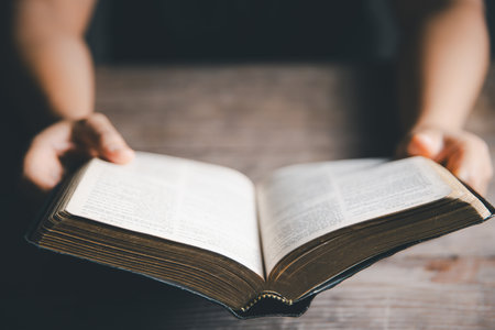 Worship christian with bible concept. Young woman person hand holding holy bible with study at home....