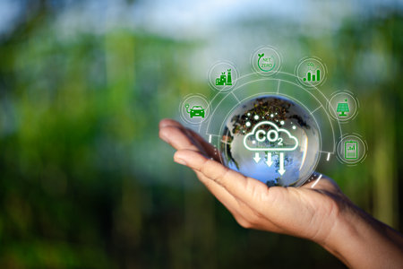 Hand holding CO2 reducing icon with virtual world for decrease carbon dioxide emission, carbon footprint and carbon credit to limit global warming from climate change concept. green environment.の写真素材