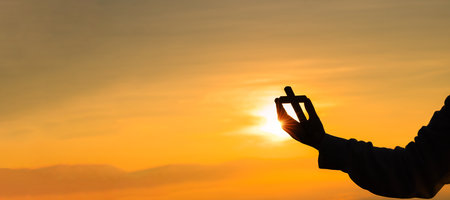Silhouette of prayer woman worship God in the morning with sunrise sky background. Person hands open palm up worship. God helping repent catholic easter lent mind pray. Christian religion concept.の写真素材