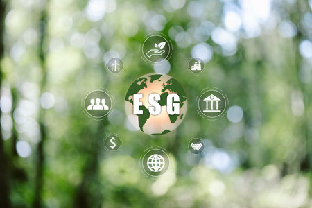 ESG icon concept in the hand for environmental, social, and governance in sustainable and ethical business on the Network connection on a green background. environmental icon, banner and copy spaceの写真素材