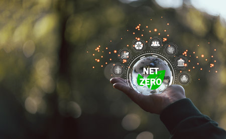 Net zero icon and carbon neutral concept in the hand for net zero greenhouse gas emissions target Climate neutral long term strategy on a green background. environmental icon, banner and copy spaceの写真素材